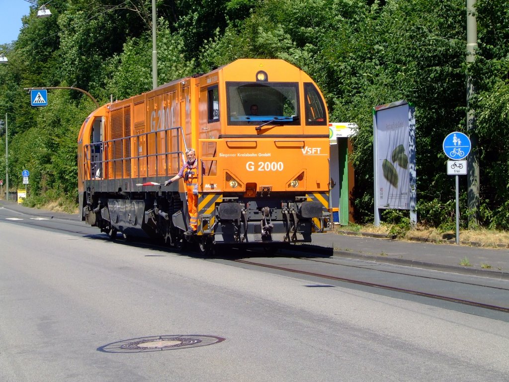 Die Mak G 2000 (Lok 43) der Kreisbahn Siegen-Wittgenstein f�hrt in Siegen-Eintracht �ber die Eiserfelder Stra�e (zum Gleisanschu� R�hrenwerk)am 19.07.2006. Das Gleis ist mittlerweile neben die Stra�e neu verlegt worden.